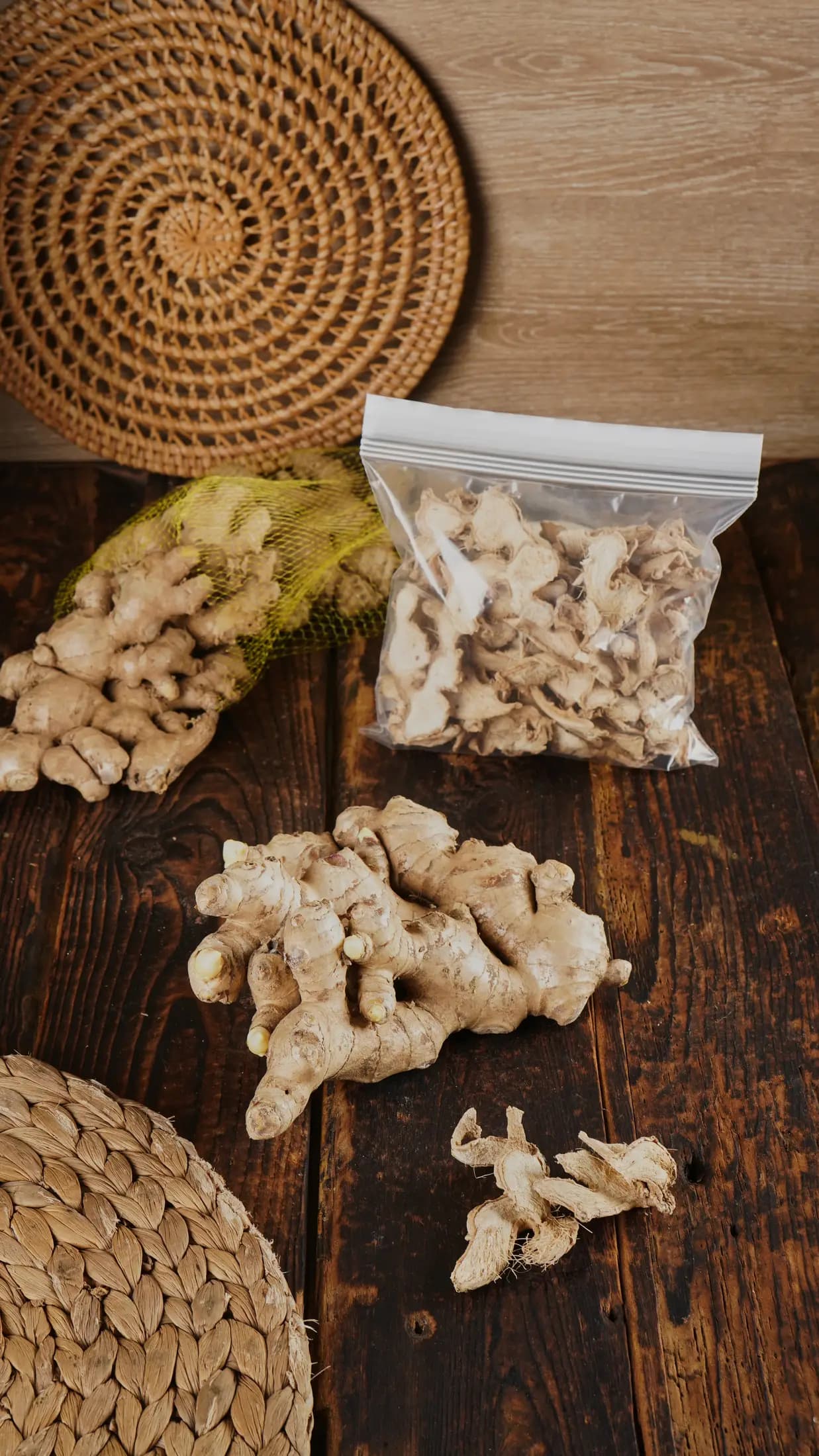 Whole Jahe Gajah rhizomes in export netting on a wooden table